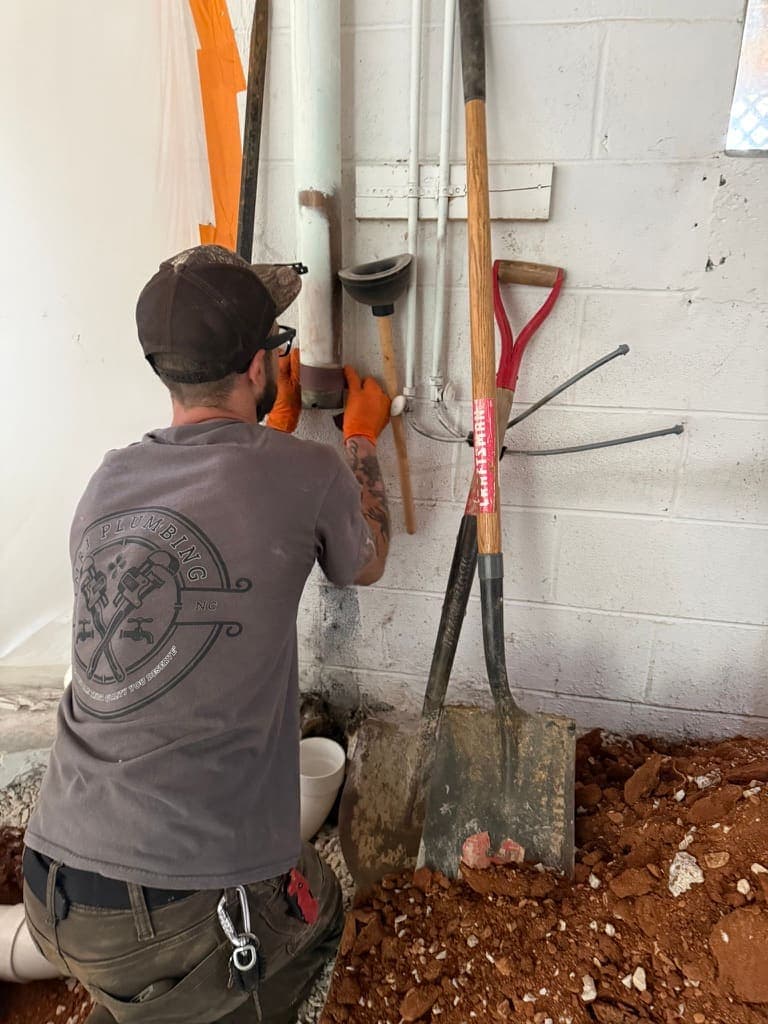 MRJ Plumbing plumber working on a job in Asheville, NC