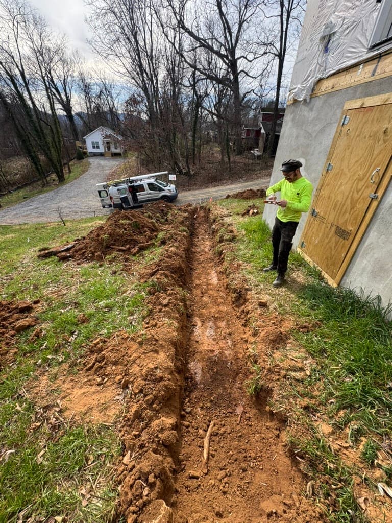MRJ Plumbing plumber on a sewer line job near Asheville, NC