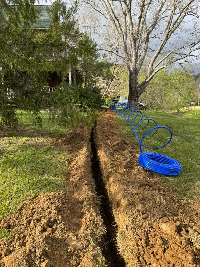 Trench for a new water service line dug by MRJ Plumbing near Asheville, NC