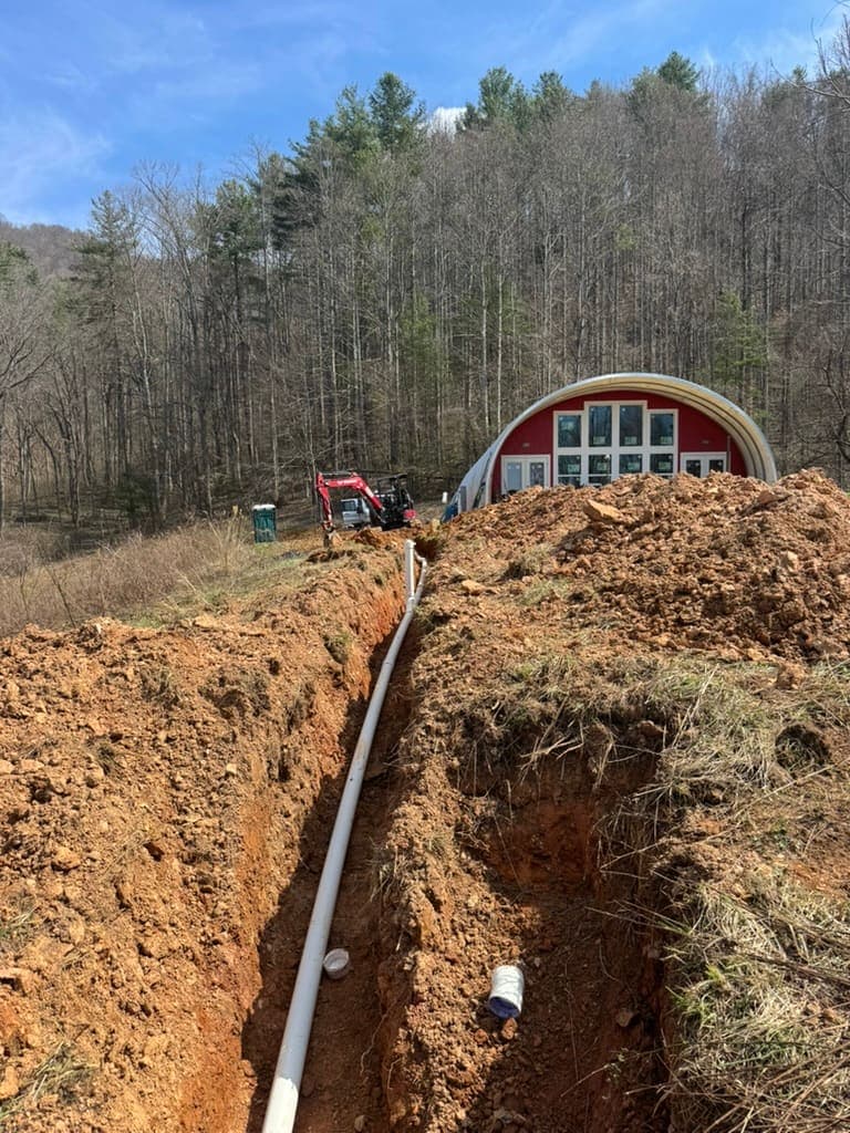 Sewer line replacement trench dug by MRJ Plumbing near Asheville, NC