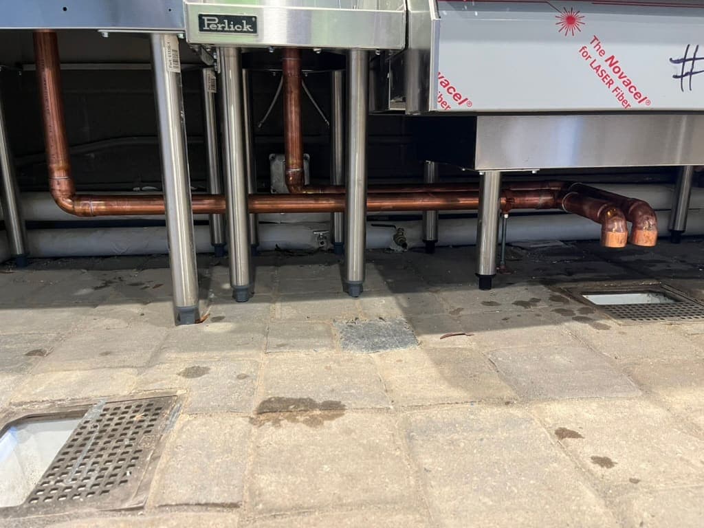 Copper drain piping under commercial kitchen sinks installed by MRJ Plumbing in Asheville, NC