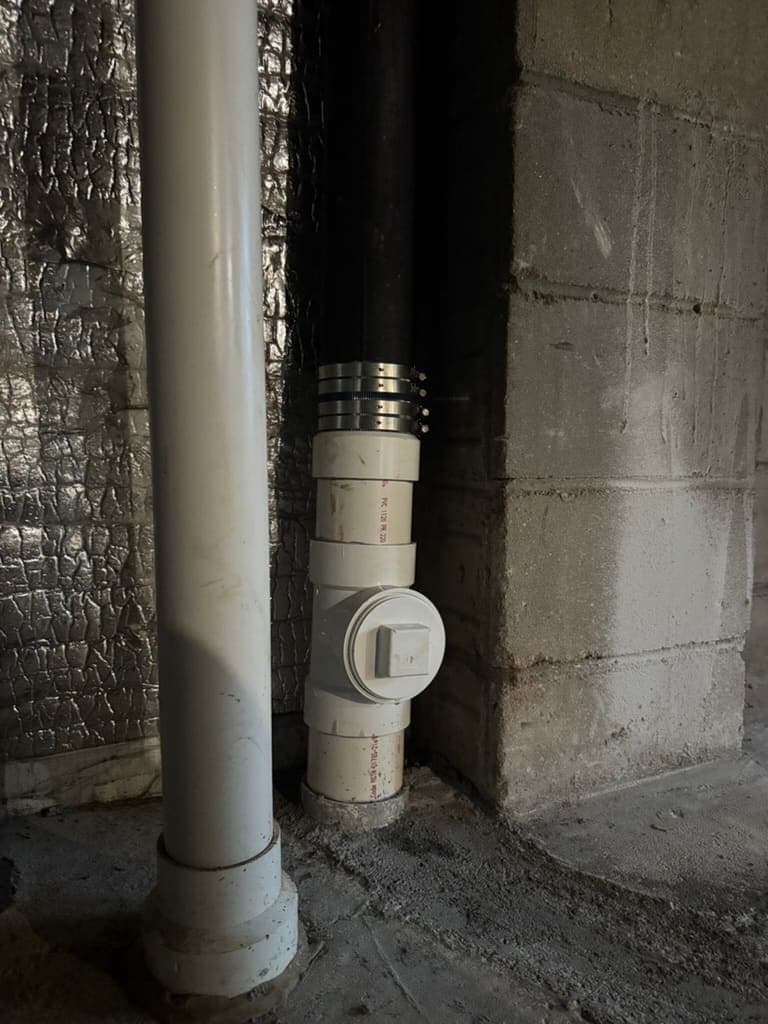 PVC cleanout fitted to a cast-iron drain stack by MRJ Plumbing in Asheville, NC
