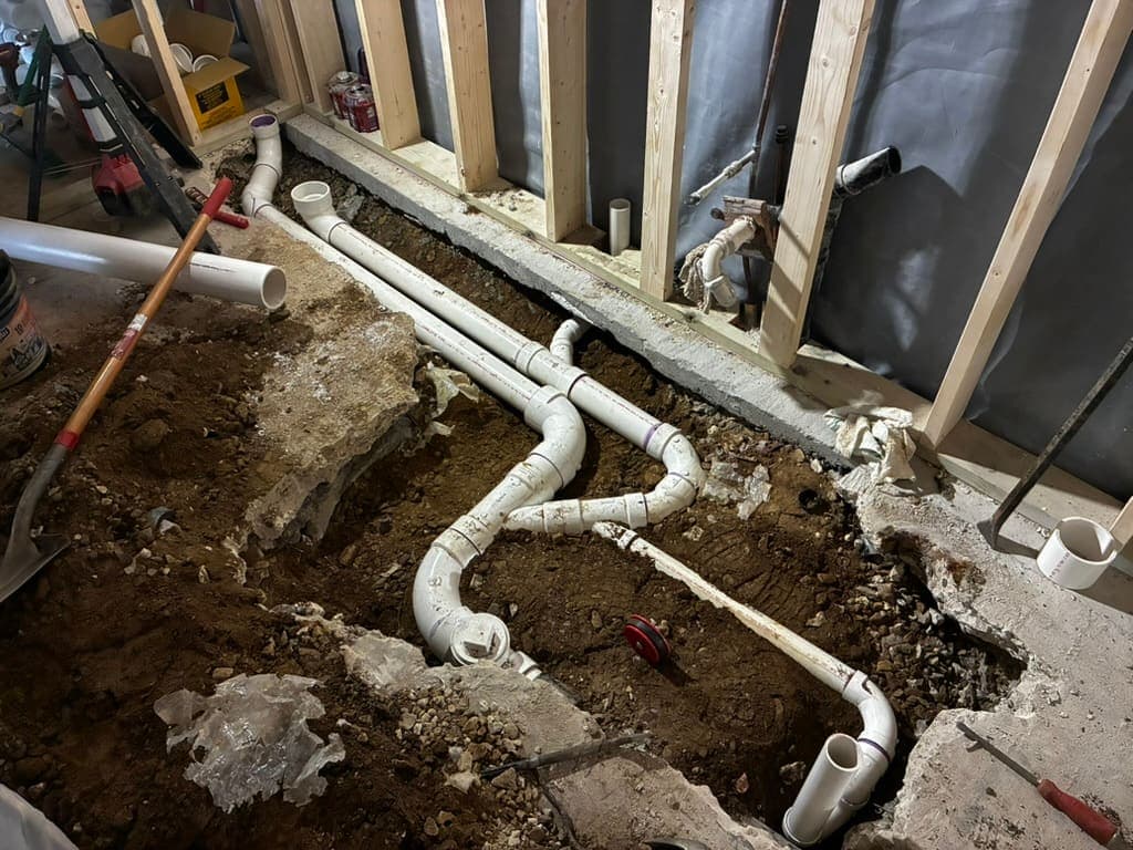 Drain lines set in a trench before concrete, a plumbing job by MRJ Plumbing in the Asheville, NC area