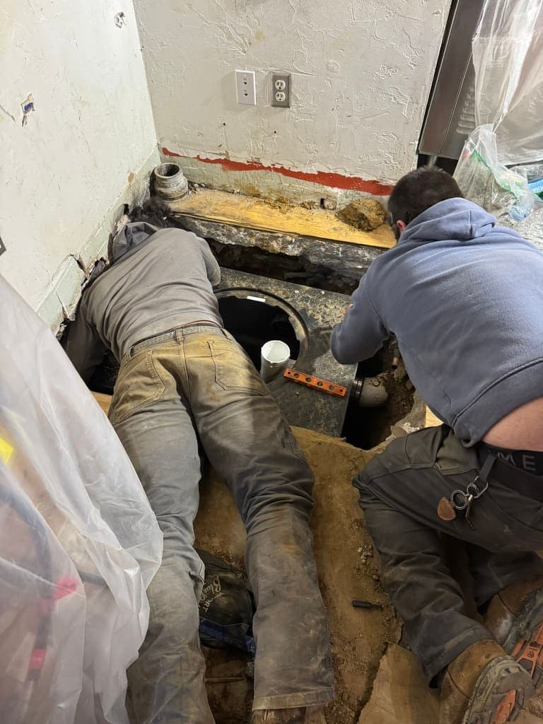 Working on a line in a crawlspace, a plumbing job by MRJ Plumbing in the Asheville, NC area