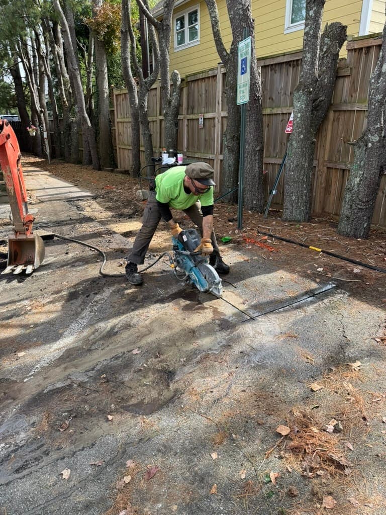 Cutting pavement for a line repair, a plumbing job by MRJ Plumbing in the Asheville, NC area