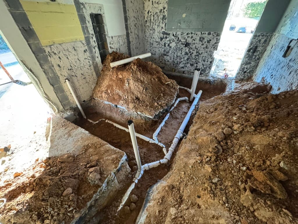 Sewer line repair inside a basement, a plumbing job by MRJ Plumbing in the Asheville, NC area