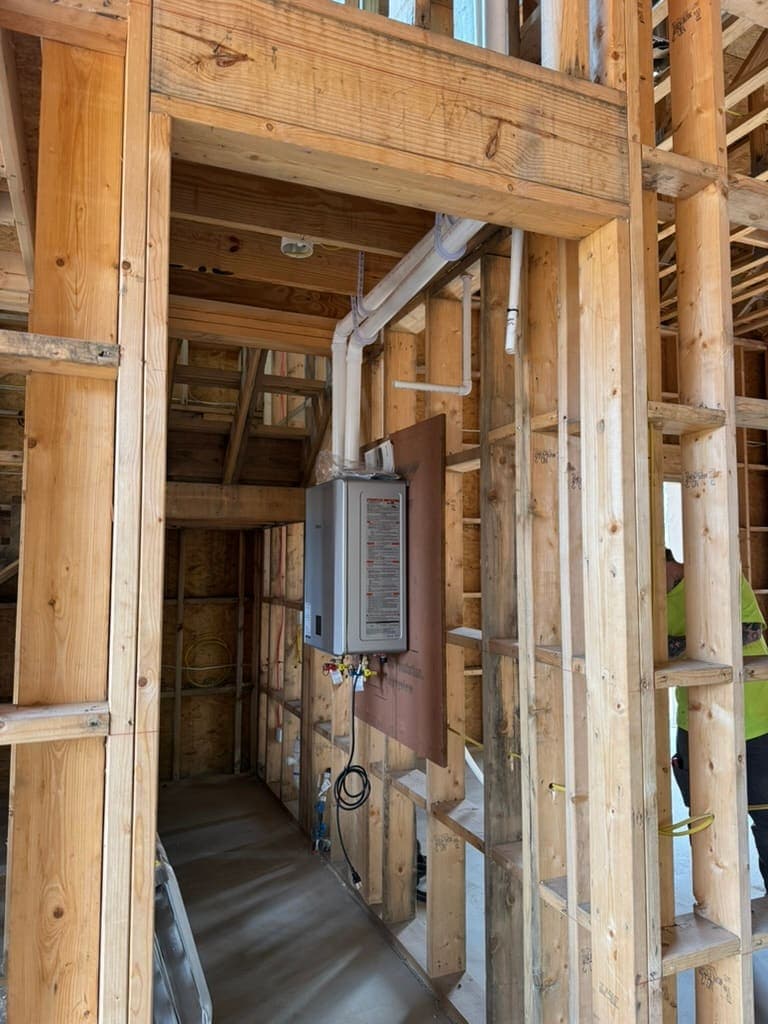 Tankless water heater mounted in new framing, a plumbing job by MRJ Plumbing in the Asheville, NC area