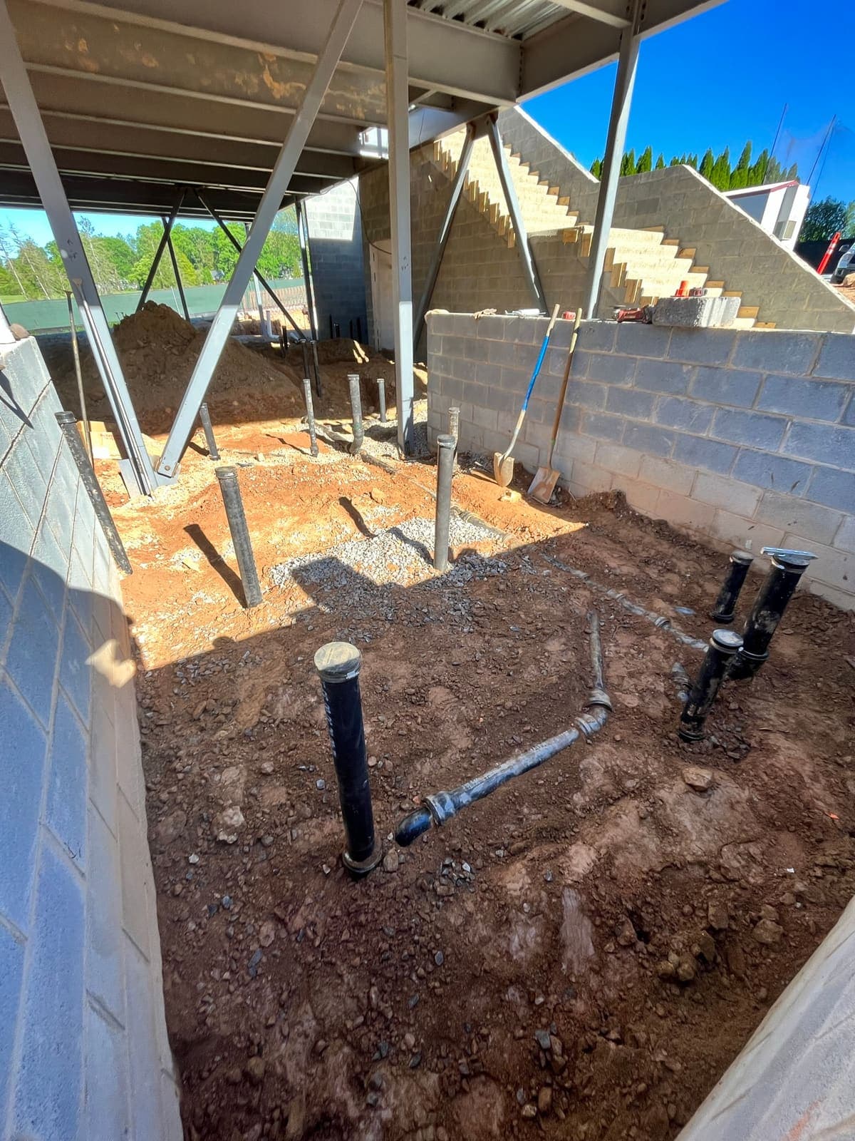 Water and sewer line connections at a building, a plumbing job by MRJ Plumbing in the Asheville, NC area